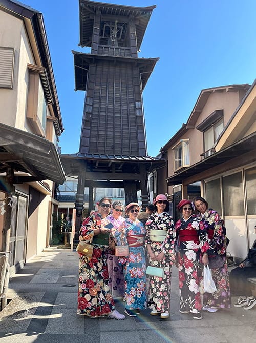 Tourists wearing rental kimono in front of Time Bell Tower in Kawagoe